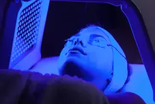Young woman with UV LEDS light facial treatment